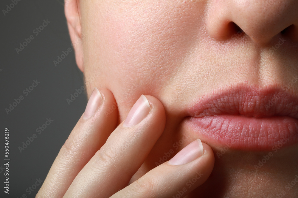 Obraz premium Closeup view of woman with healthy skin on grey background