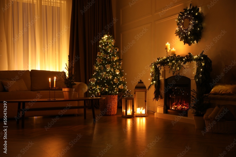 Fototapeta premium Beautiful room interior with fireplace and Christmas decor in evening