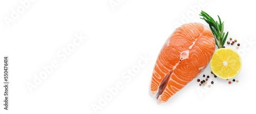 Fresh raw salmon steak with rosemary, peppercorns and lemon on white background, top view. Banner design
