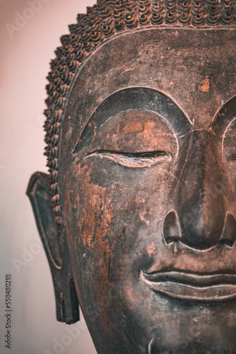 Ancient buddha bronze head in Lampoon, Thailand
