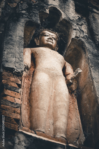 Schilderij op canvas Ancient buddha standing in Lampoon, Thailand