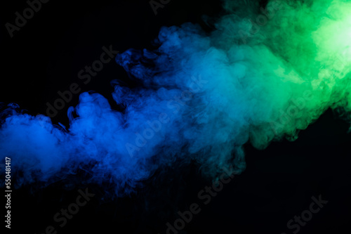 Green-blue smoke in neon light on black background.