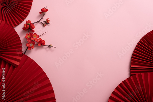 Chinese New Year celebration background with red paper fans and flowers. Asia traditional cultural decoration. Empty space. decoration backdrop idea for the year-end party. photo