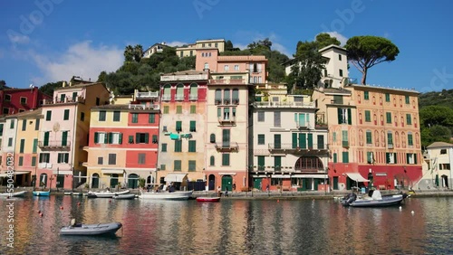 Boat sail inside the Portofino. A lot of colourfully painted buildings that line the shore.