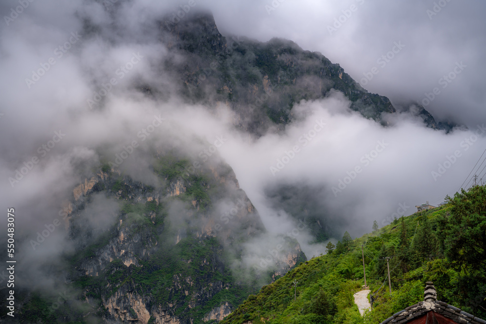 Clouds around Tiger Leaping Gorge, a scenic canyon on the Jinsha River, a primary tributary of the upper Yangtze River in China. It's one of the deepest and most spectacular river canyons in the world