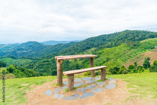 wood bar and chair with mountain hill background