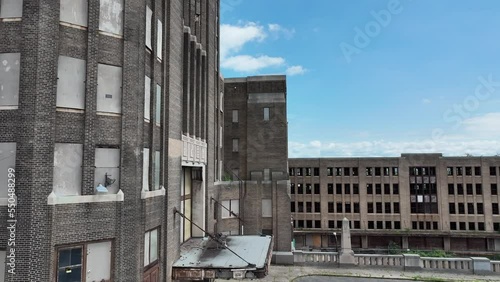 An aerial sliding view of the architecture and brick front of the Grand Central Station in Buffalo, New York with the city in the background.