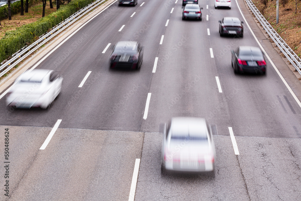 to look at a vehicle passing on the road from the bridge