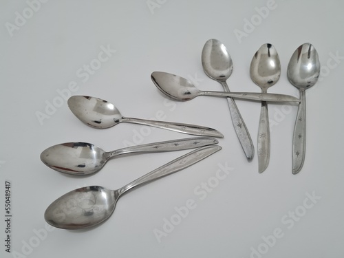 A collection of shiny silver spoons made of iron