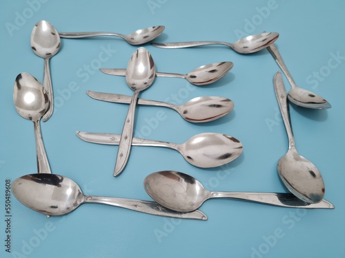 A collection of shiny silver spoons made of iron