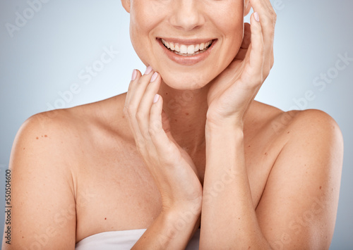 Happy woman, skincare and beauty cosmetics for shine, wellness and healthy glow on studio background. Closeup of model touching face after facial, laser results and chemical peel for clean aesthetics