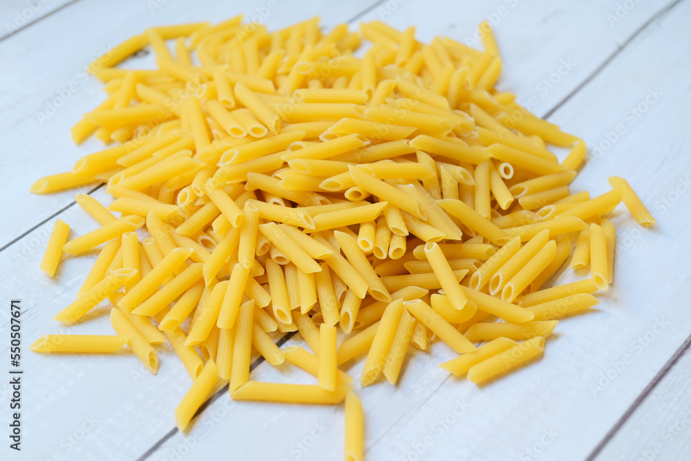 Penne pasta background, close up raw penne pasta rigate pasta uncooked delicious pasta for cooking food