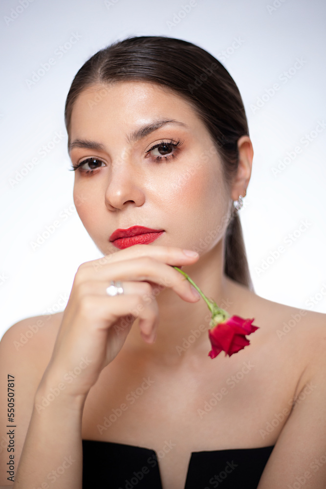 Beautiful girl with small spray roses. Beautiful white girl with flowers. Woman with bright makeup. Beautiful girl with small spray roses. Beautiful white girl with flowers. Woman with bright makeup.