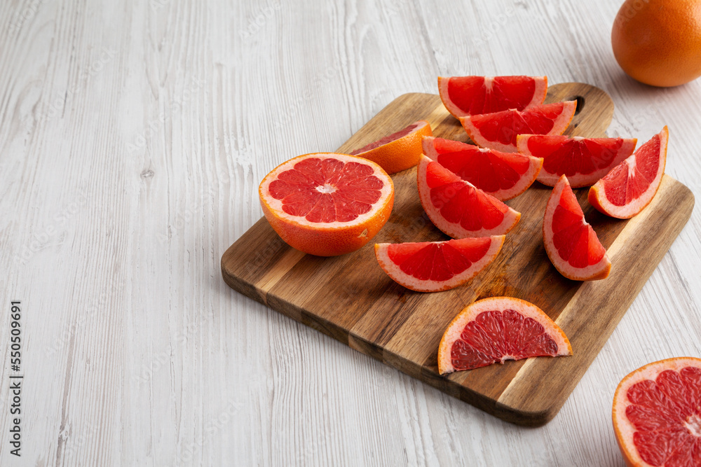 Organic Red Ruby Grapefruit on a Wooden Board, side view. Copy space. Organic Red Ruby Grapefruit on a Wooden Board, side view. Copy space.
