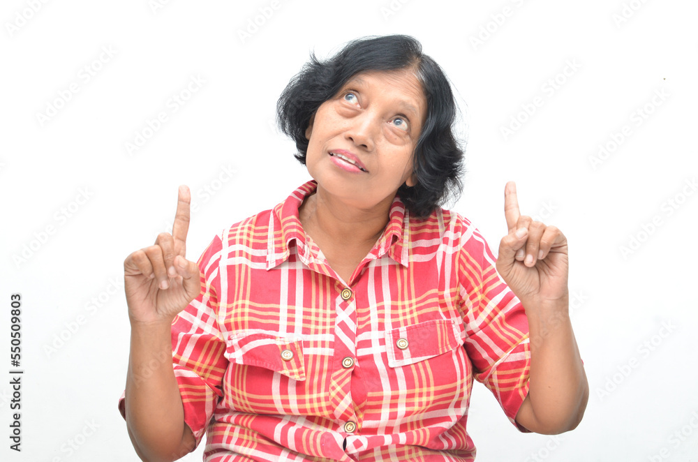 Portrait of happy ecstatic senior asian woman pointing finger and hand presenting gesture giving advice and suggestion. concept having idea. Portrait of happy ecstatic senior asian woman pointing finger and hand presenting gesture giving advice and suggestion. concept having idea.