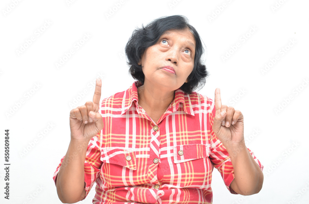 Portrait of happy ecstatic senior asian woman pointing finger and hand presenting gesture giving advice and suggestion. concept having idea. Portrait of happy ecstatic senior asian woman pointing finger and hand presenting gesture giving advice and suggestion. concept having idea.