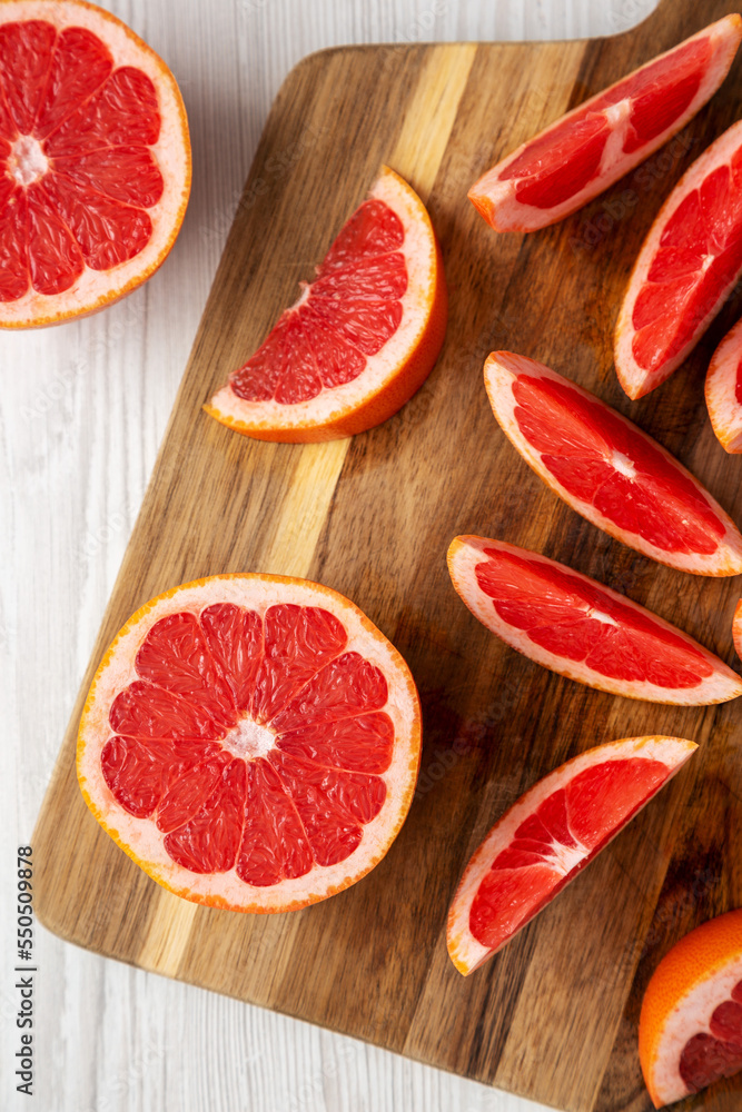 Organic Red Ruby Grapefruit on a Wooden Board, top view. Overhead, from above, flat lay. Organic Red Ruby Grapefruit on a Wooden Board, top view. Overhead, from above, flat lay.