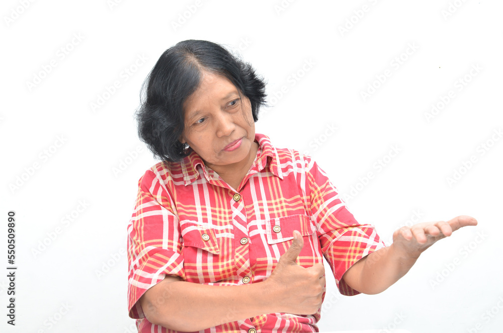 Portrait of happy ecstatic senior asian woman pointing finger and hand presenting gesture giving advice and suggestion