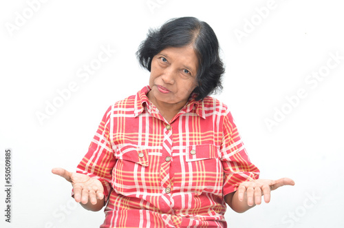 Portrait of happy ecstatic senior asian woman pointing finger and hand presenting gesture giving advice and suggestion