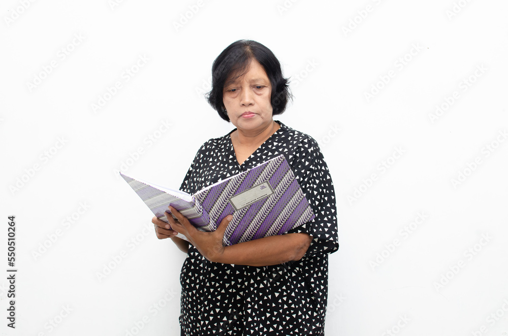 asian senior woman thinking while holding book account managing household livingcost asian senior woman thinking while holding book account managing household livingcost