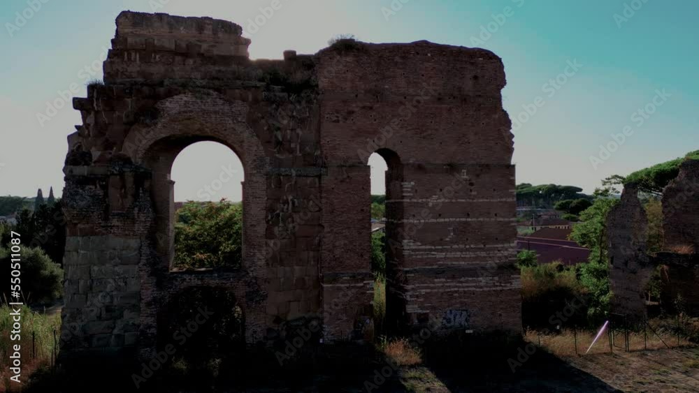 Ruins in archaeological park of Tor Fiscale, Rome in Italy. Aerial drone descending. Sunbeams Ruins in archaeological park of Tor Fiscale, Rome in Italy. Aerial drone descending. Sunbeams