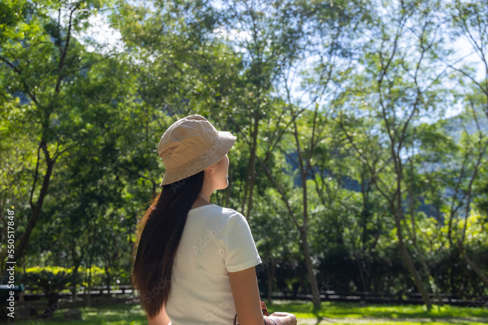 Woman feel relax in the park under sunlight