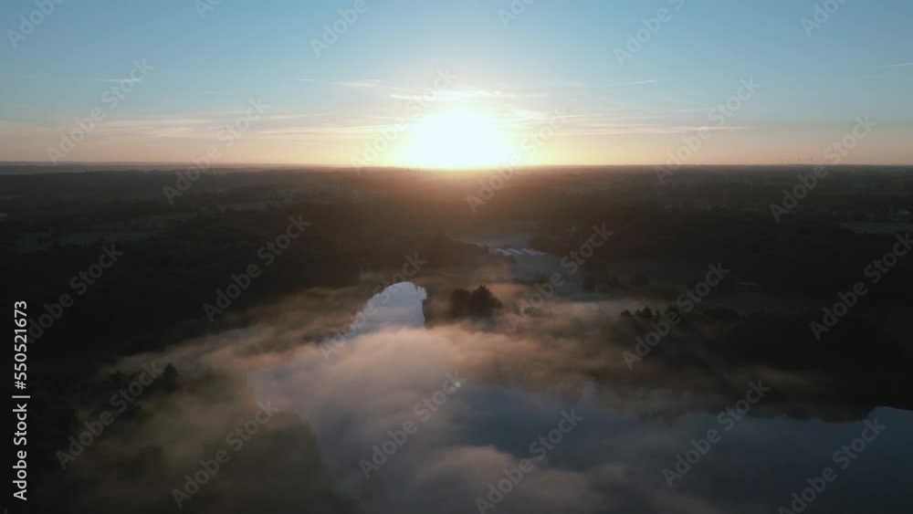 Drone flying over Moulin Neuf or New Mill pond with sunset on horizon, Rochefort-en-Terre in Brittany. Aerial forward Drone flying over Moulin Neuf or New Mill pond with sunset on horizon, Rochefort-en-Terre in Brittany. Aerial forward