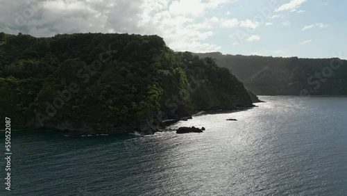 Aerial Flying Over Nuaailua bay Towards Forested Maui Coastline. Dolly Forward photo