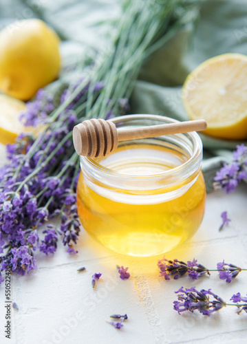 Jar with honey and fresh lavender flowers
