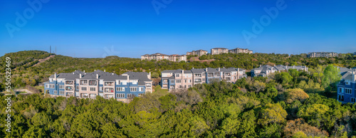 Fotografia Austin, Texas- Adjacent townhouses and apartment buildings on top of a green slo