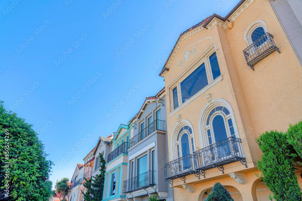 Three-storey homes with reflective windows and window railings at San Francisco, California