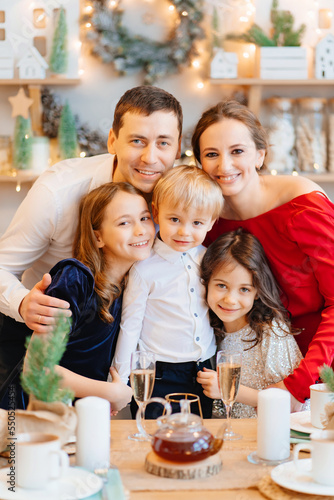 Beautiful big family in the kitchen with Christmas decor. to cook together.