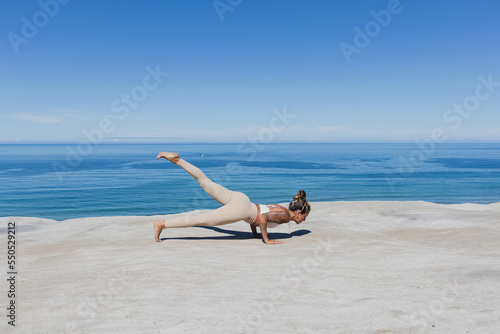 One legged chaturanga Eka pada chaturanga yoga on the beach