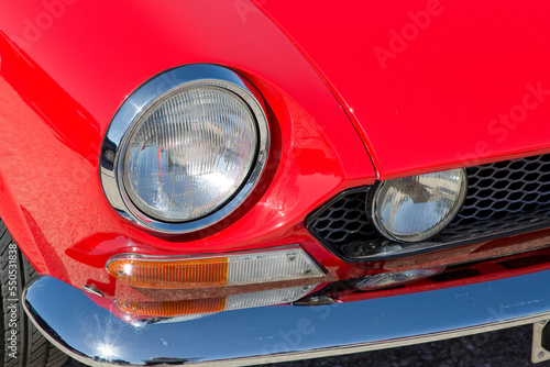 Detail of an headlight of a vintage italian red sport car © Francesco Scatena