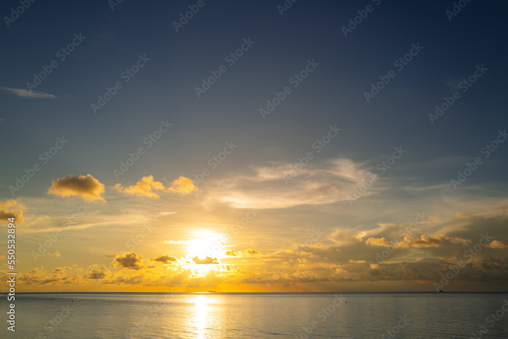 Obraz premium Sunset on sea background. Nature wallpaper with summer sea. Water sea texture. Calm sunrise on tropical sea. Calm ocean.