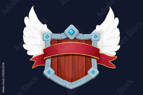 Stone and wooden victory shield with wings, medieval with gemstones and award ribbon in cartoon style isolated on white background. Game weapon, frame, menu element. 