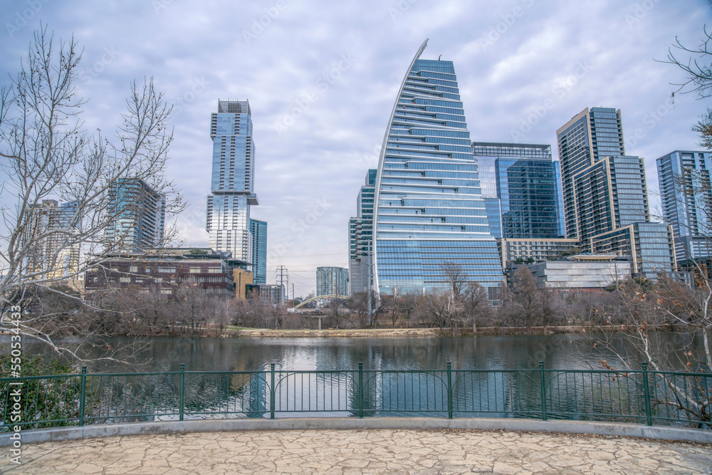 Fototapeta premium Colorado river with reflection of the buildings view from Butler Metro Park- Austin, Texas