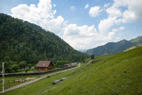 A house in a village in a picturesque mountain valley in summer.