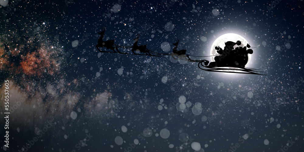 Fototapeta premium Santa Claus flies on Christmas Eve in the night sky with snow
