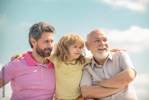 Three generations of men together, portrait of smiling boy, dad and granddad. Men generation portrait of grandfather father and son child. Fathers day. Men in different ages.