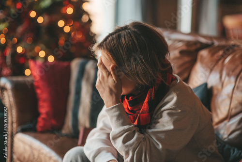 Portrait of candid authentic dreamer boy teenager in sadness depressing emotion at home Xmas