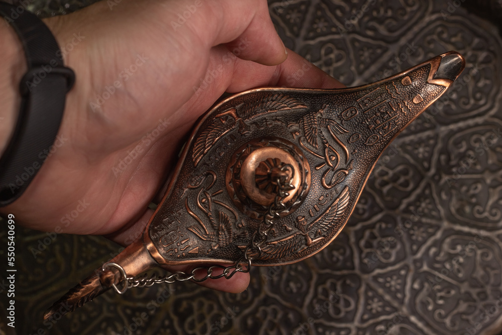 Fototapeta premium Aladdin's magic lamp isolated on black background
