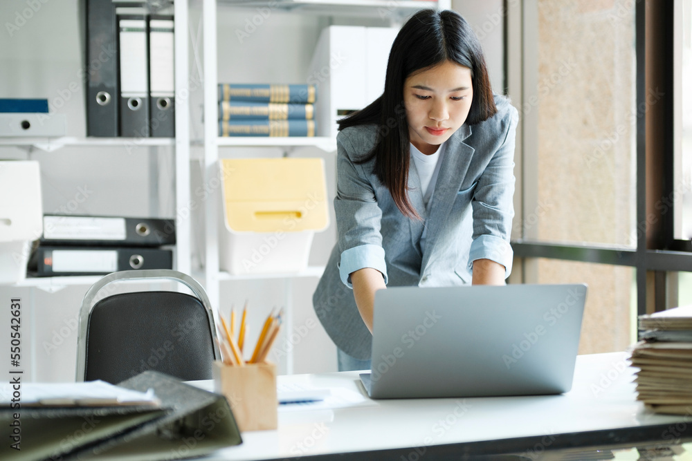 Young asian businesswoman working at office using laptop. Young asian businesswoman working at office using laptop.