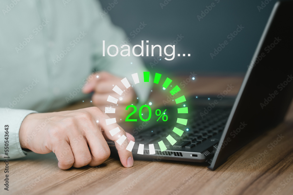 Man using laptop for download software and waiting to loading digital business data form website, concept of waiting for load of loading bar. - obrazy, fototapety, plakaty 