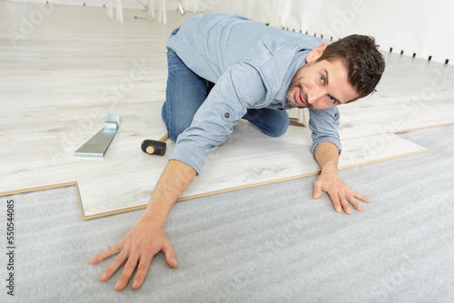 carpenter man installing wooden floor