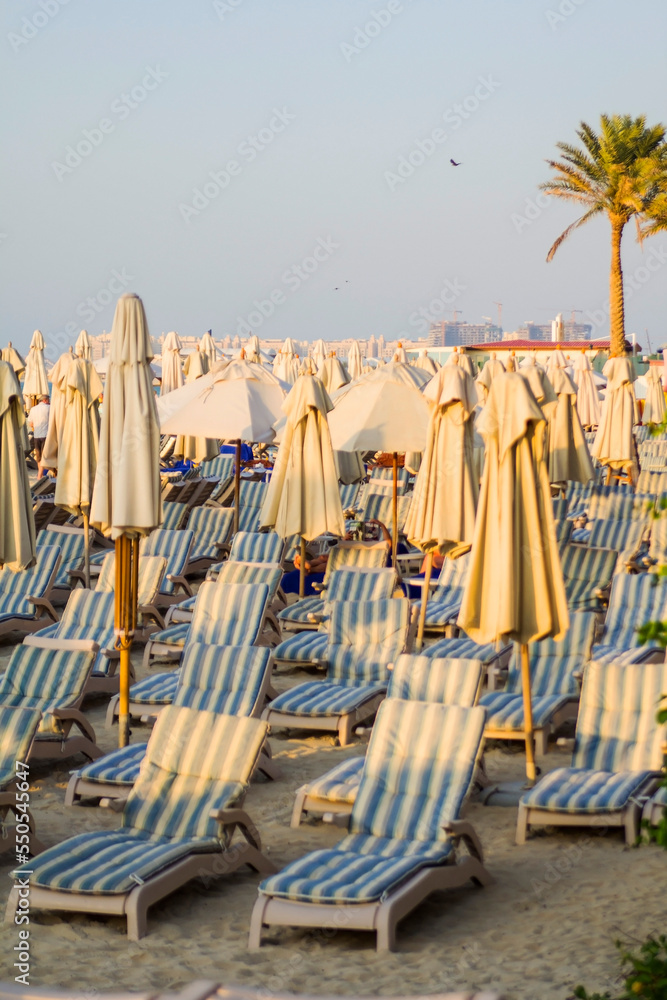 Poster Print photo background of beautiful striped sun loungers and umbrellas on the beach in 26.7x40 cm