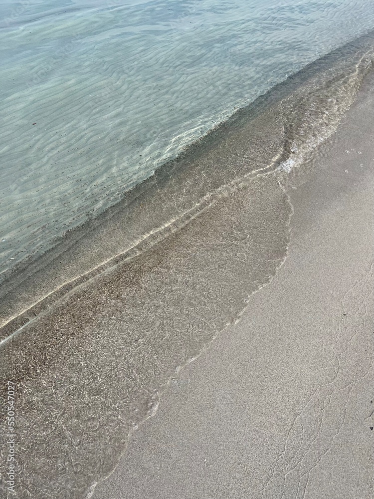 Obraz premium Sea shore, sandy beach and transparent sea water, natural background