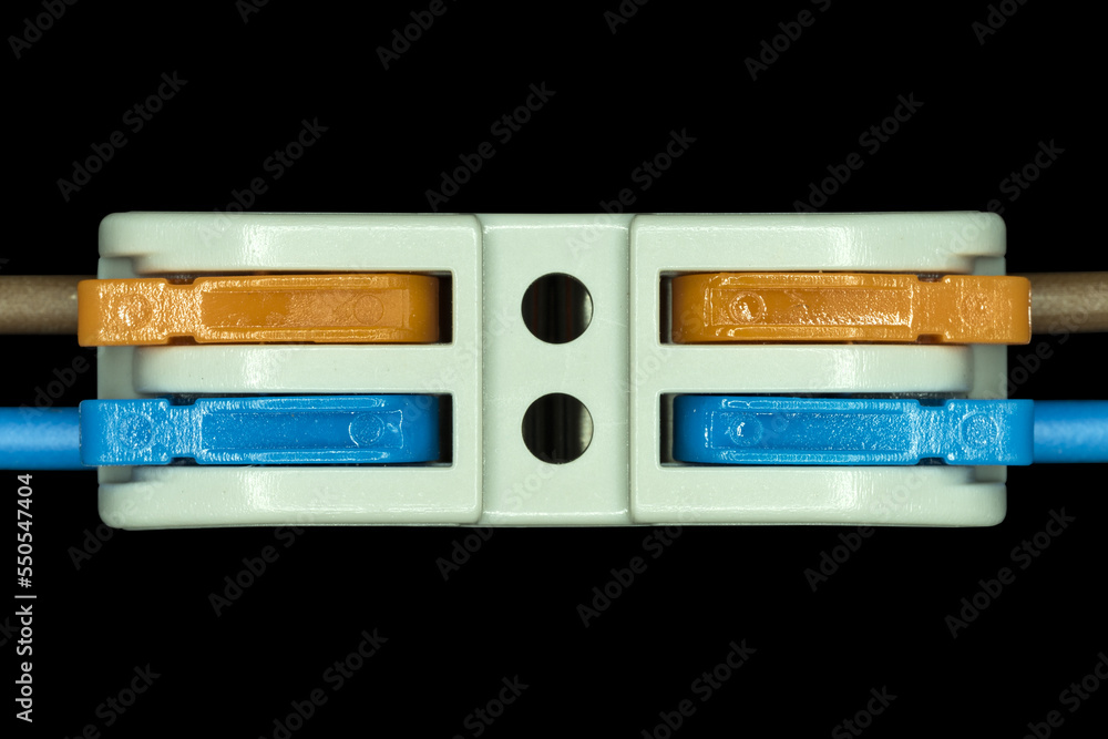 Fototapeta premium Compact splicing connector isolated on black background.