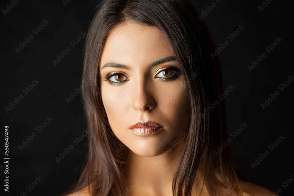 Close-up portrait of young woman with golden makeup. Close-up portrait of young woman with golden makeup.