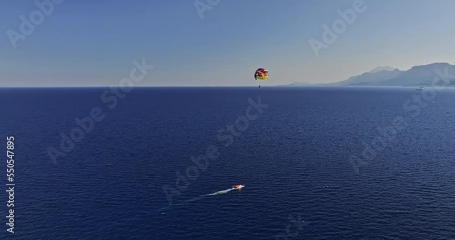 Antalya Turkey Aerial v10 drone flyover capturing parasail flying high in the sky above deep blue see overlooking at muratpaşa coastal cityscape and mountainscape - Shot with Mavic 3 Cine - July 2022 photo